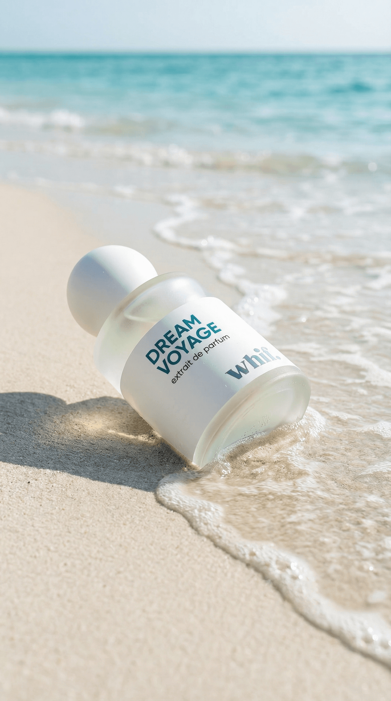 Dream Voyage perfume bottle lying on wet sand beside the shoreline